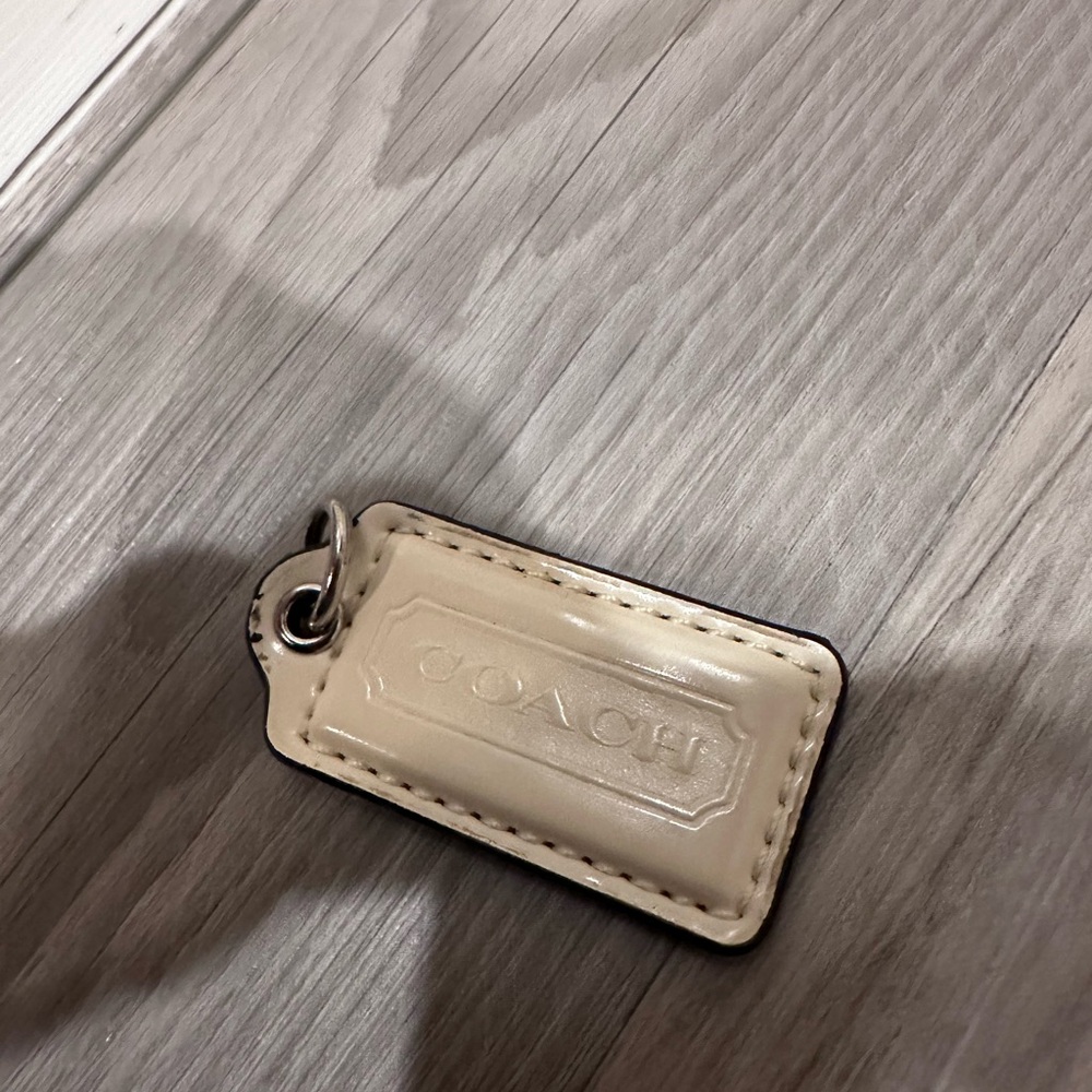 Coach white leather hangtag bag charm.